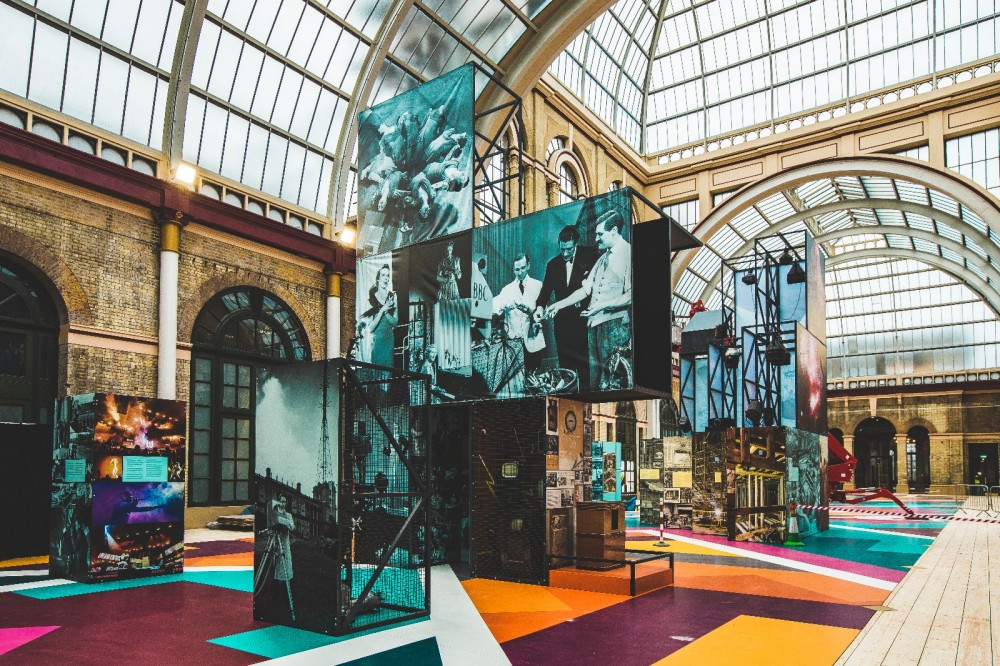 Mixed reality exhibition in an open space with columns and skylights.