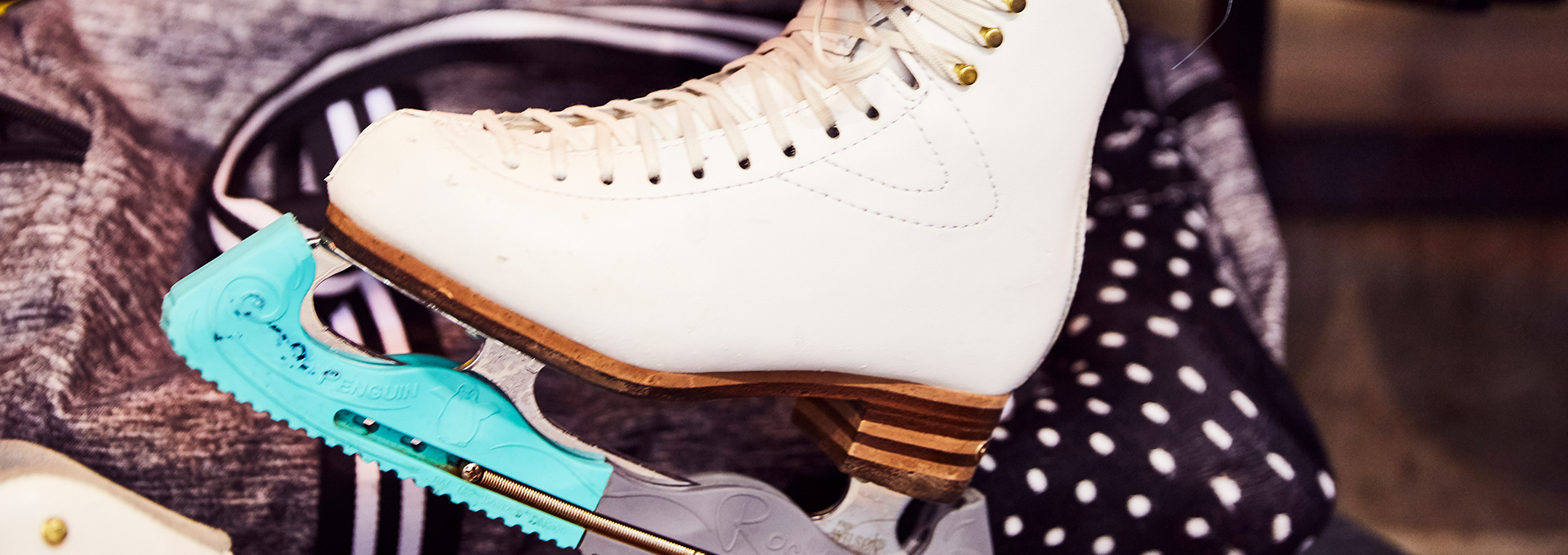 A white ice skate on a polka dot background.