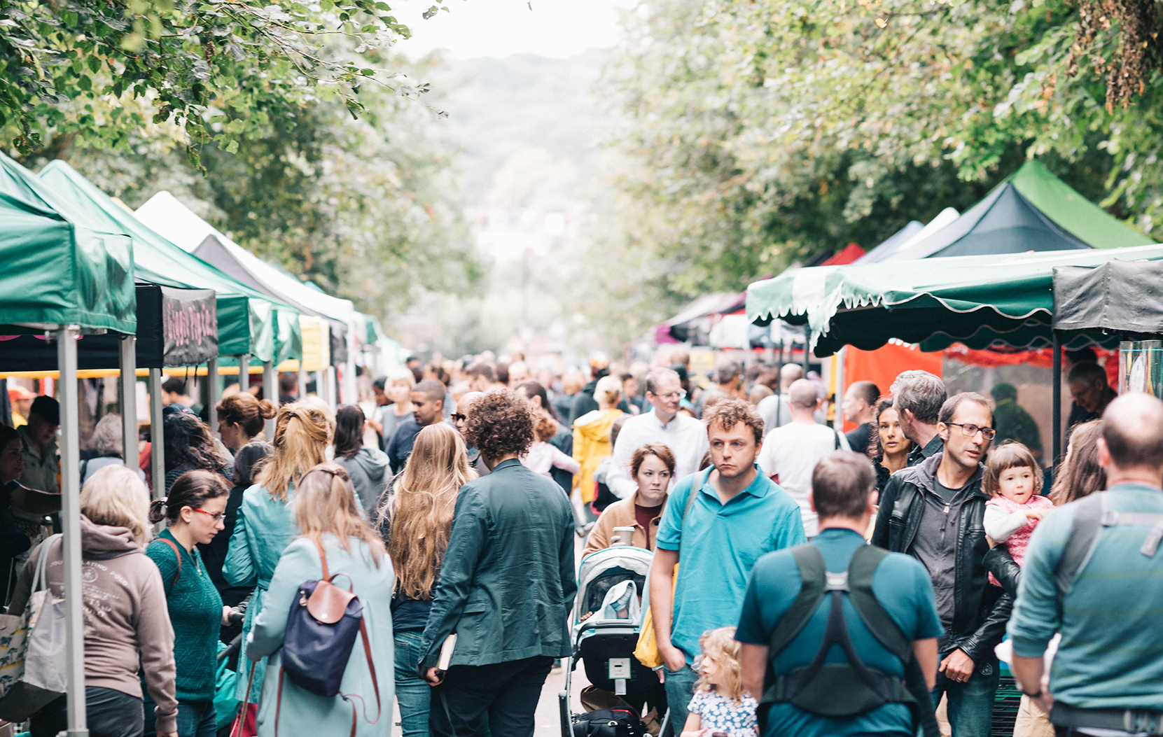 People enjoying Alexandra Palace's Farmer's Market walking through the stalls.